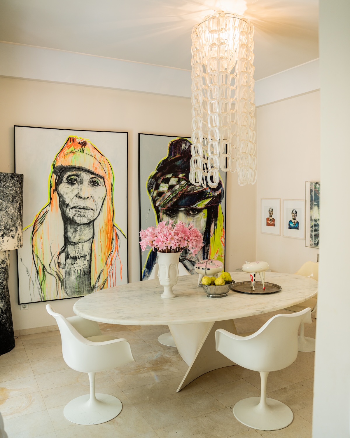 Dining room with marble table and portraits