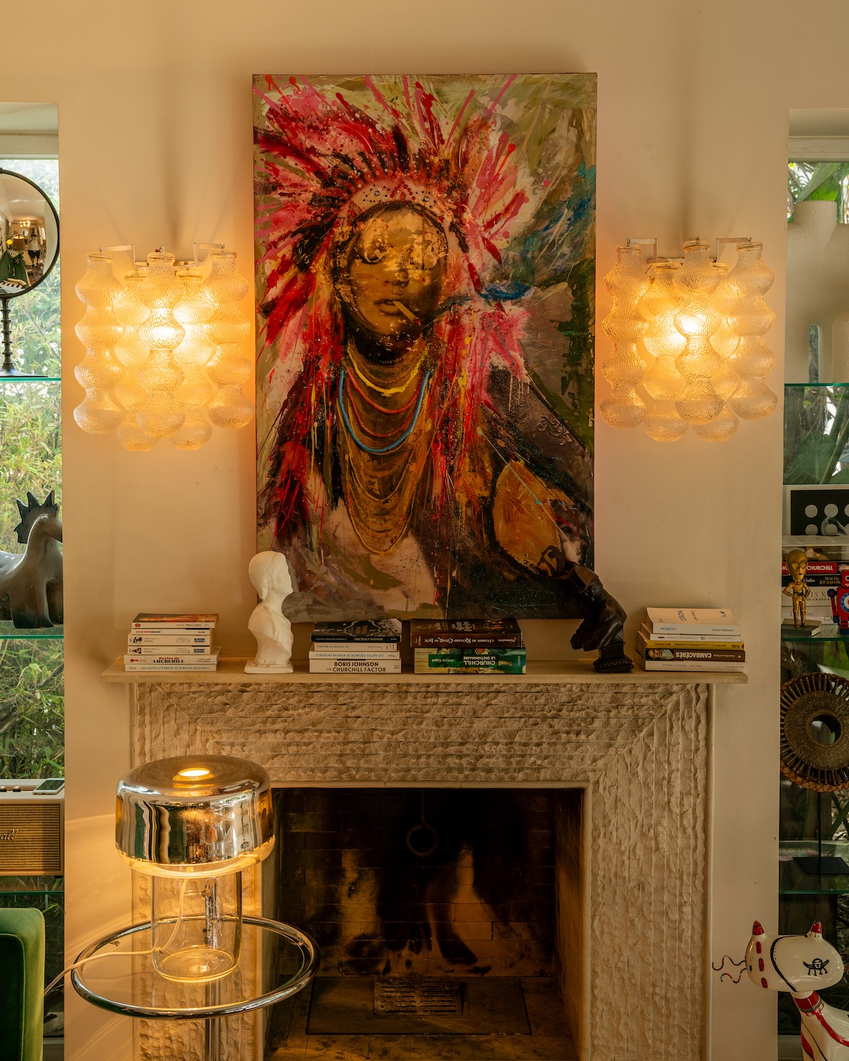 Fireplace with large painting and glass wall lights