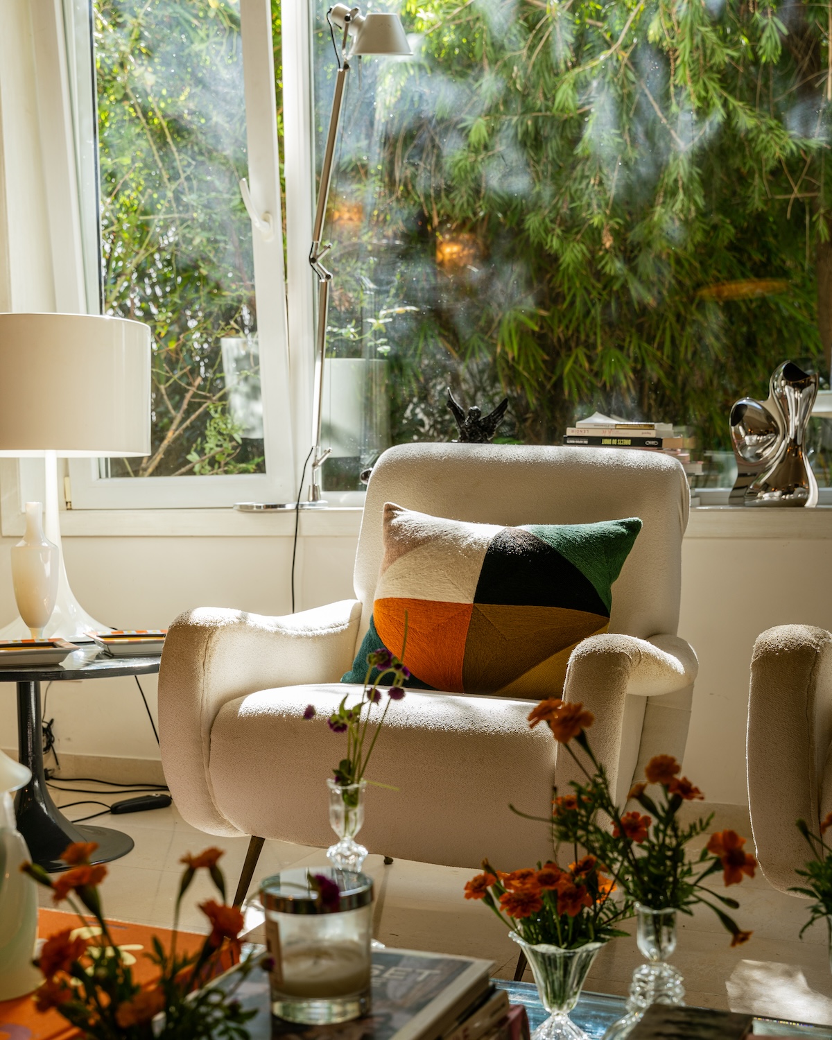 Armchair with colourful cushion by the window