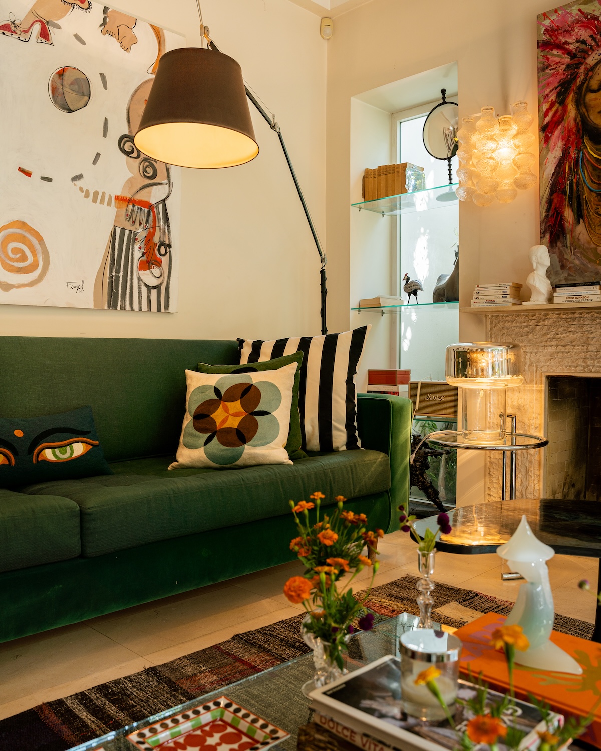 Green sofa and floor lamp beside the fireplace