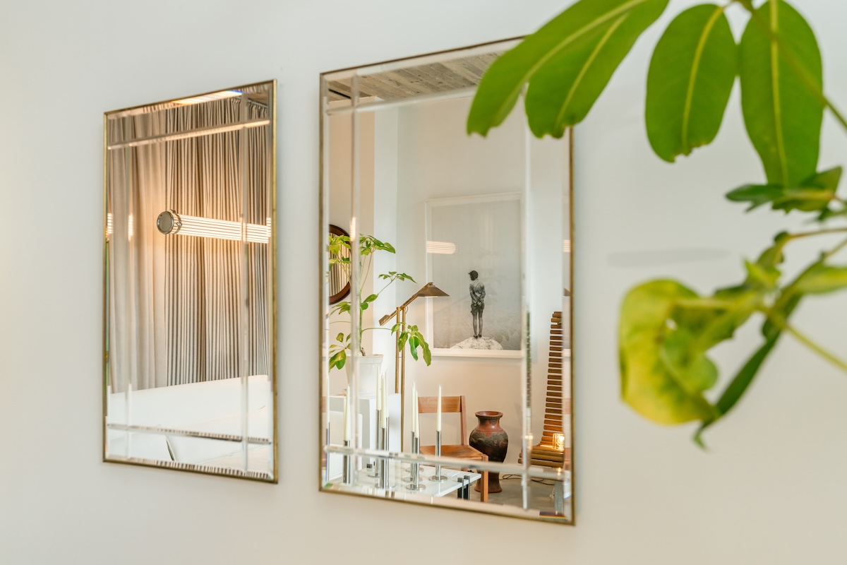 Mirrors reflecting furnishings and greenery in the Improvisation #6 interior
