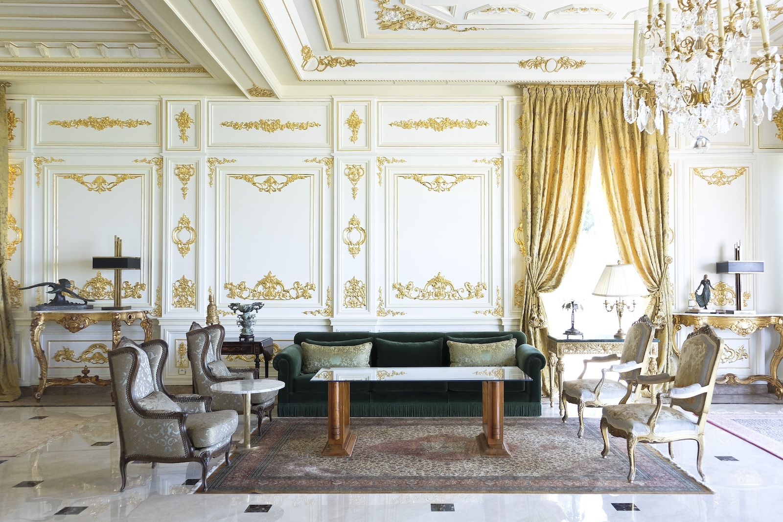 Petit Palais salon with green velvet sofa and gilded architectural details