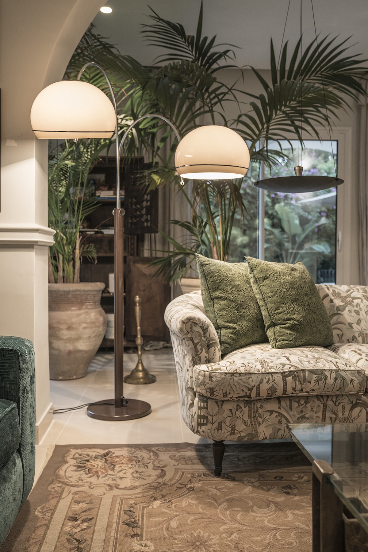 Patterned armchair and sculptural floor lamps