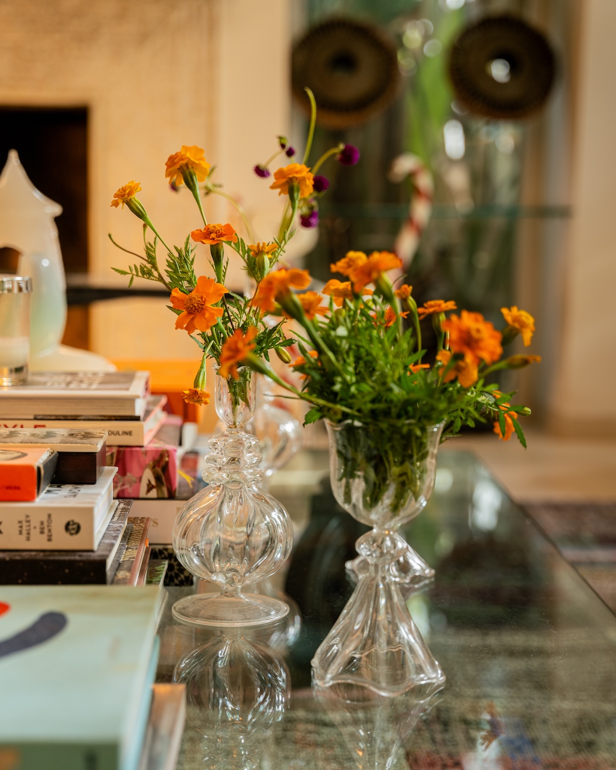 Orange flowers in glass vases on the coffee table