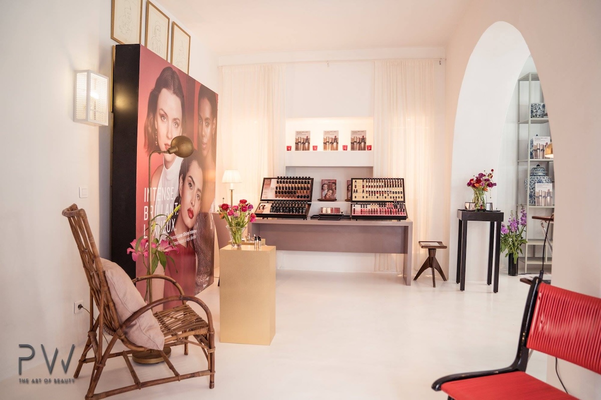 Bobbi Brown launch space with make-up displays, campaign panels and rattan armchair