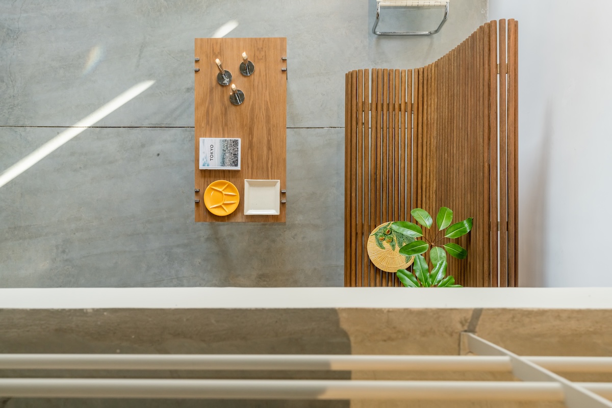 Overhead view of a wooden table, slatted screen and plant in the Improvisation #6 setting