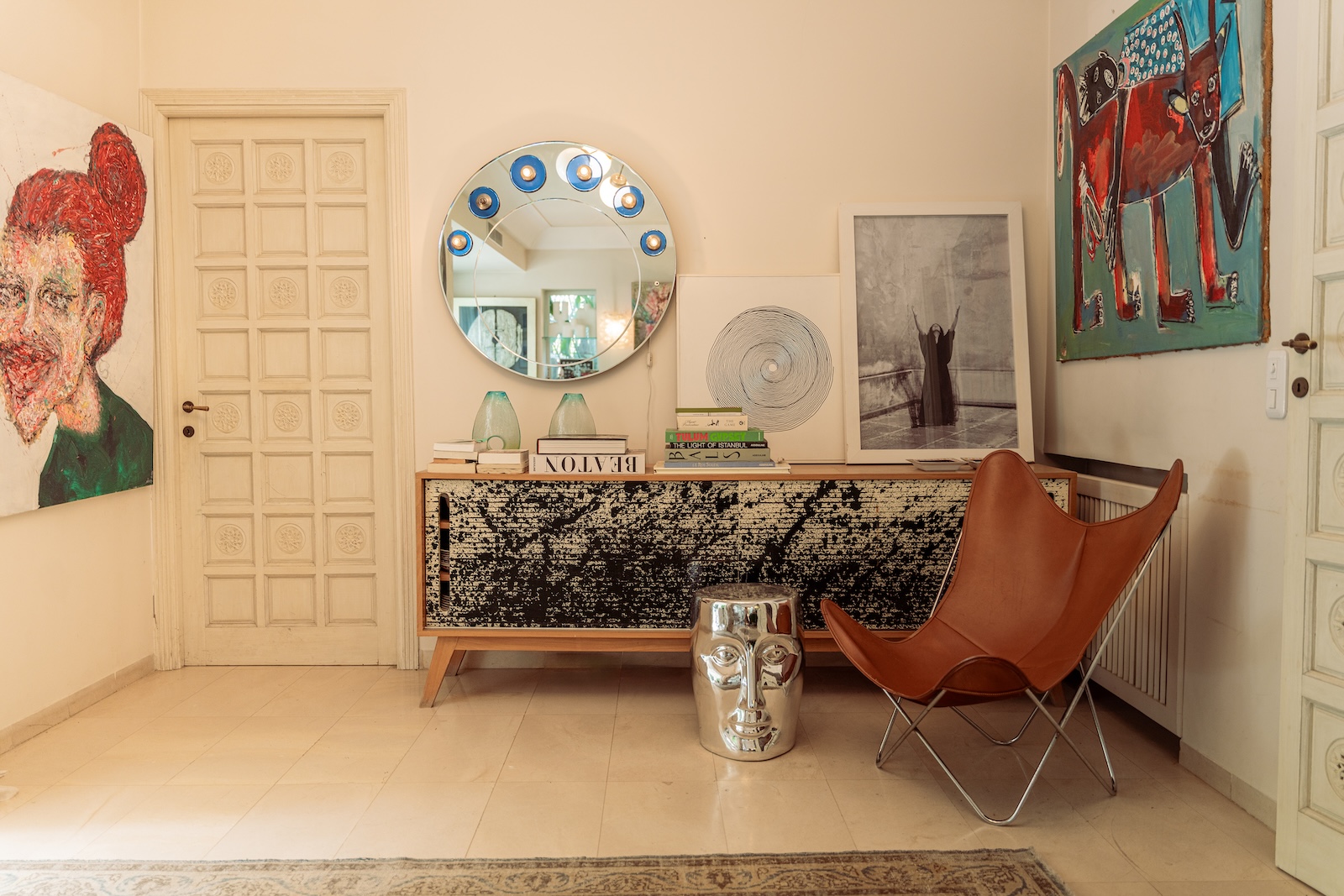 Sideboard with round mirror and leather butterfly chair