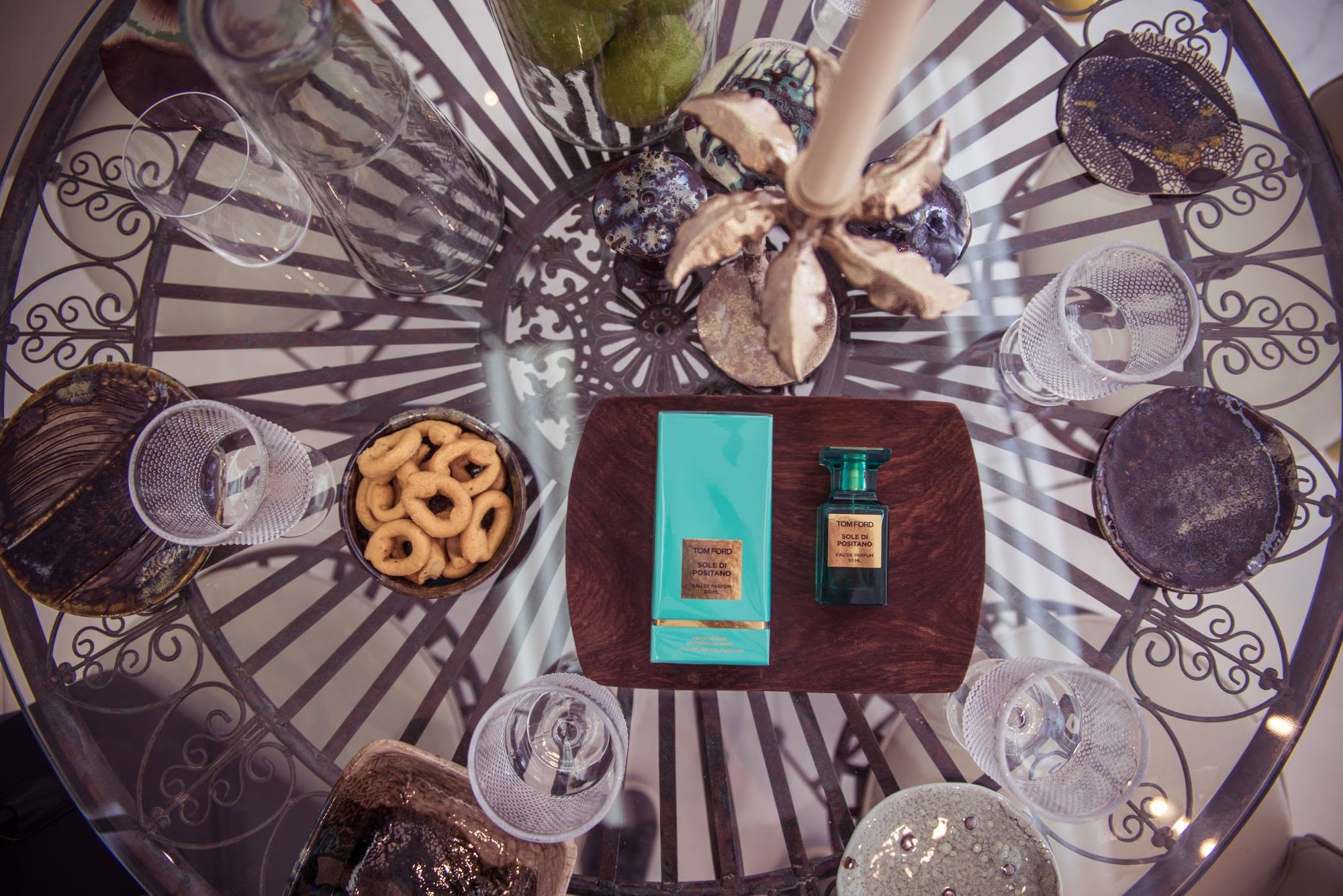 Tom Ford Sole Di Positano fragrance arranged on a glass table